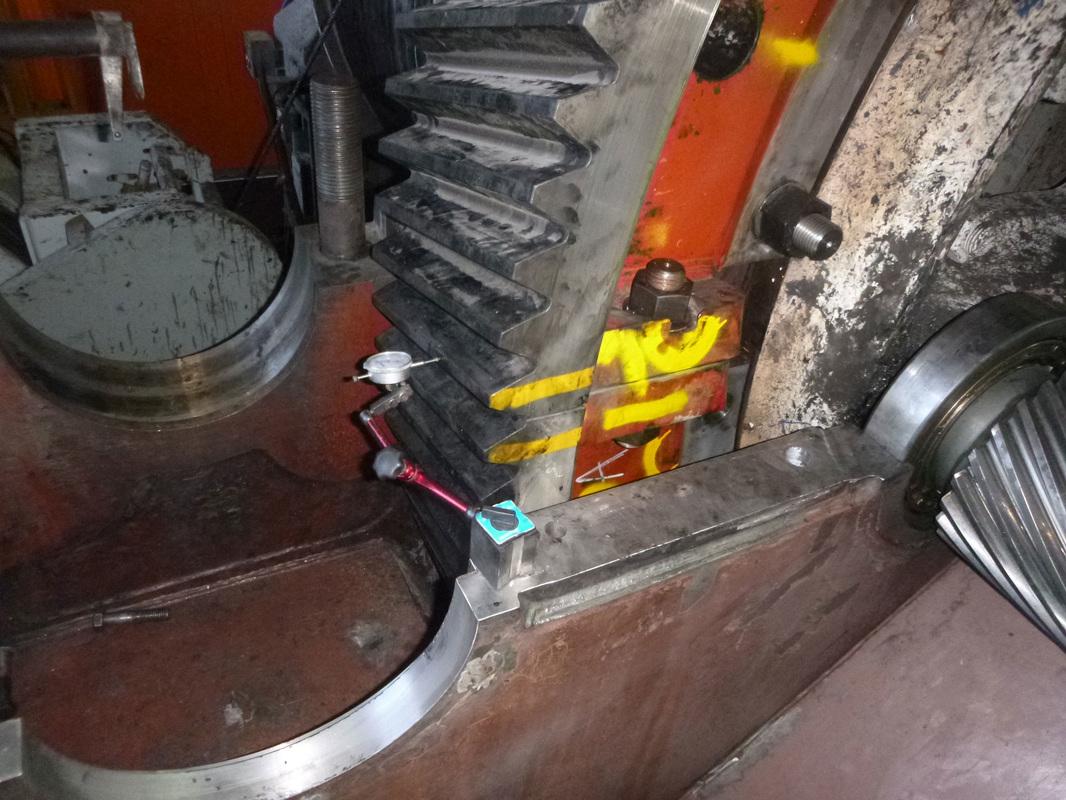 Dial indicator set up against the rack teeth of a dragline propel gear during in-situ measurement