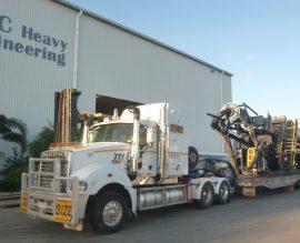 Prime mover with an oversize float load leaving the ABC Heavy Engineering yard at Paget