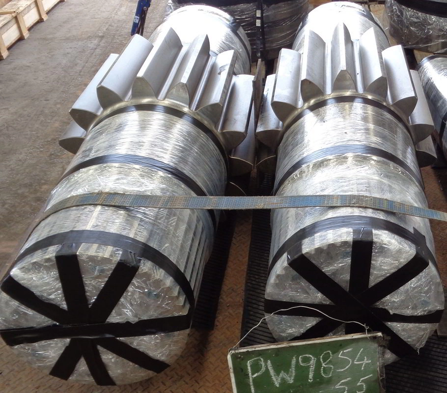 Matched pair of large machined pinion shafts tagged PW985, taped for protection and cradled on timbers awaiting press assembly