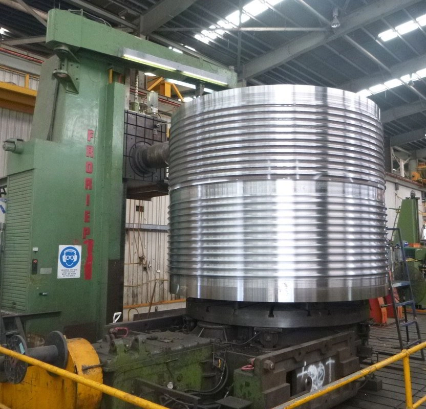 CNC vertical borer machining a large ribbed cylindrical steel component in the ABC workshop